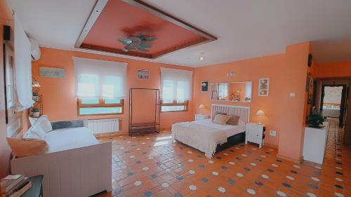 a living room with two beds and a couch at Casa Rural El Mirador de la Vega in Horche
