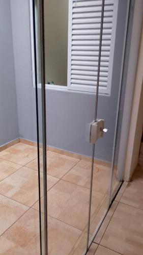 a glass door in a room with a tile floor at Cozy Home 1 in Boituva