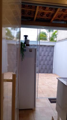 a kitchen with a door open to a patio at Cozy Home 1 in Boituva