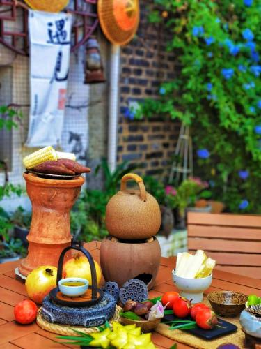 a table topped with different types of food on it at Guilin Tranquil Peaks Retreat by Reed Flute Cave in Guilin