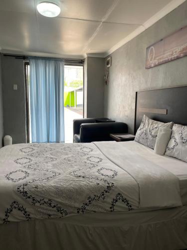 a bedroom with a large bed and a window at DA LIFE Guest House in Springs