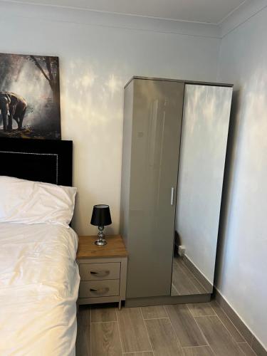 a bedroom with a sliding glass door next to a bed at Beautiful 2-bedroom in Grays close to Lakeside in Grays Thurrock