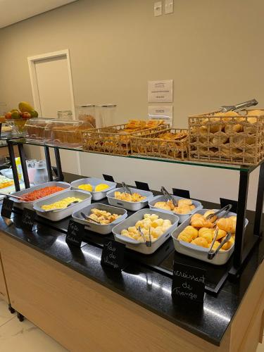 a buffet line with many different types of food at HS Hotel in São Paulo