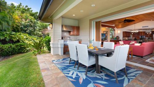 a patio with a table and chairs on a yard at ❤PiH❤ Hale Kanani Hilton Resort PassesFully Detached HomeBeach Gear Bikes in Waikoloa