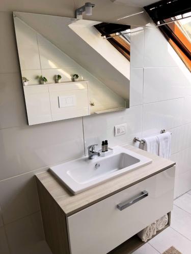 a bathroom with a sink and a mirror at RentuGoo Cuveglio-Lago maggiore in Canonica