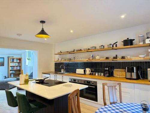a large kitchen with a counter and a kitchen island at April Cottage in Eastbourne