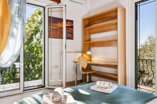 a bedroom with a bed and a large window at Verani Residence Parking Balcony Playground in Sívros