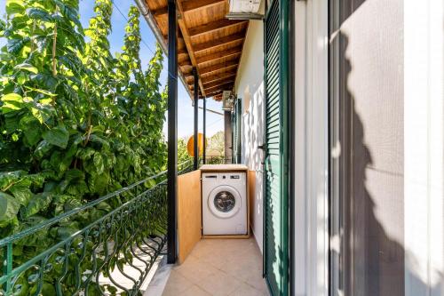 a washing machine on a balcony of a building at Verani Residence Parking Balcony Playground in Sívros