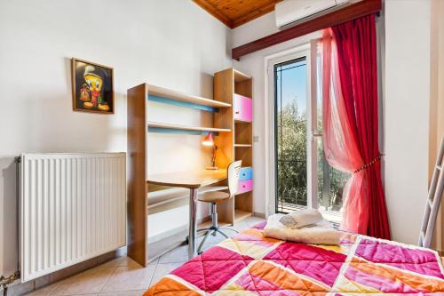 a bedroom with a bed and a desk and a window at Verani Residence Parking Balcony Playground in Sívros