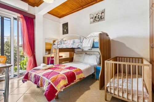 a bedroom with a bunk bed and a crib at Verani Residence Parking Balcony Playground in Sívros