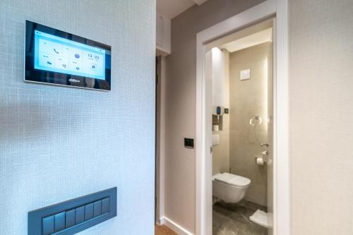 a bathroom with a flat screen tv on a wall at The Residence 59 in Belgrade