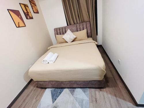 a bed in a room with two towels on it at Agile TRX Luxury suite Bukit bintang in Kuala Lumpur