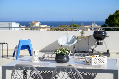 a blue table and chairs on a patio at Alba - Open Plan Apartment in Artemida