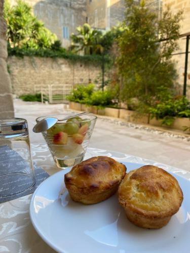 two muffins on a white plate on a table at B&B Kabala in Lecce