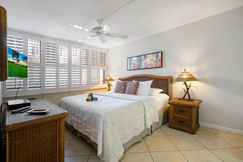 a bedroom with a bed and a ceiling fan at Gorgeous Luxury Ocean View 1 Bedroom Kamaole Sands 10-304 in Wailea