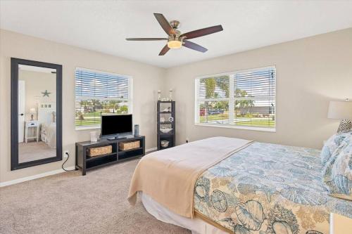 a bedroom with a bed and a ceiling fan at 265 Belvedere in Punta Gorda