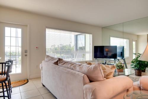 a living room with a white couch and a tv at 3 Mi to Ocean Riverfront Apartment in Vero Beach! in Vero Beach