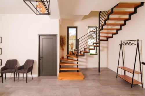 a staircase in a house with two chairs and a table at Dili Dream Villa in Dilijan