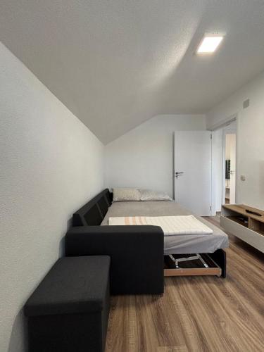 a bedroom with a bed and a couch in it at Villa Gjorgjevikj in Kumanovo