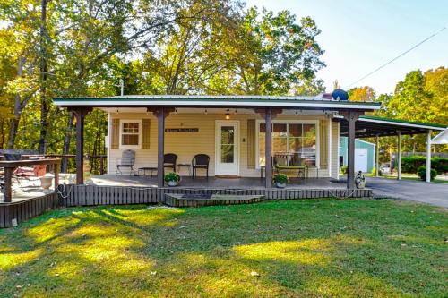 a small yellow house with a porch at 1 Mi to Buchanan Resort Home with Deck and Yard! in Durham Subdivision