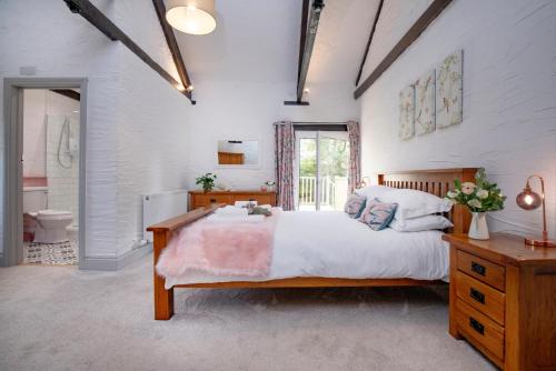 a bedroom with a large bed and a bathroom at The Old Mill in Paignton