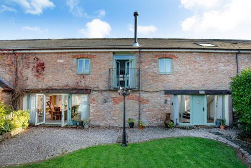 an exterior view of a brick house at The Old Mill in Paignton