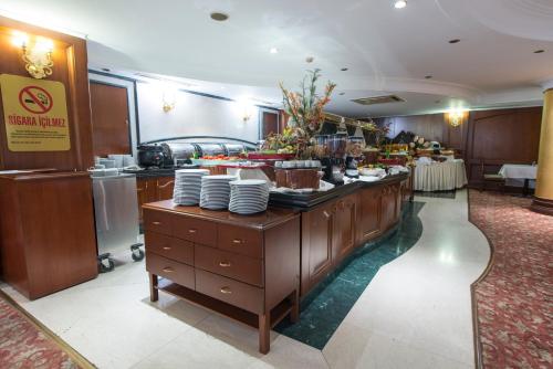 a buffet line in a hotel with dishes on it at Akar International Hotel in Ankara