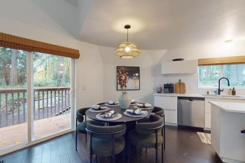 a kitchen with a table and chairs and a kitchen with a balcony at Dome Away From Home in Gig Harbor