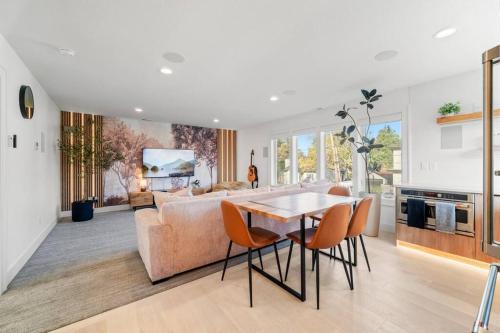 a living room with a table and a couch at Parkrose Heights Luxury Experience in Portland