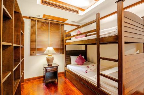 a bedroom with two bunk beds and a lamp at Patong Seaview Luxury Villa Penda in Patong Beach