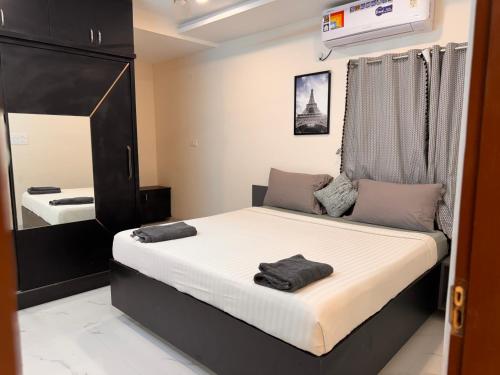 a bedroom with a large bed and a mirror at PRIVATE Luxury Homestay in Khammam in Khammam