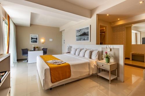 a bedroom with a large bed in a room at eSuites Lagoa Santa in Lagoa Santa