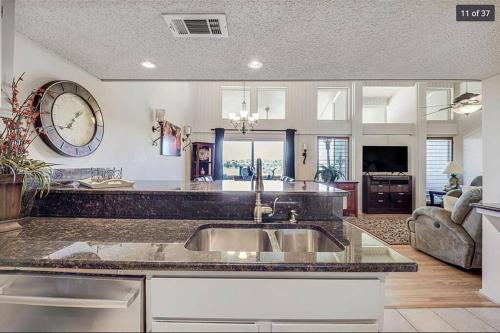 a kitchen with a sink and a living room at 3 story with Lake Views, Golf, Amenities in Leander