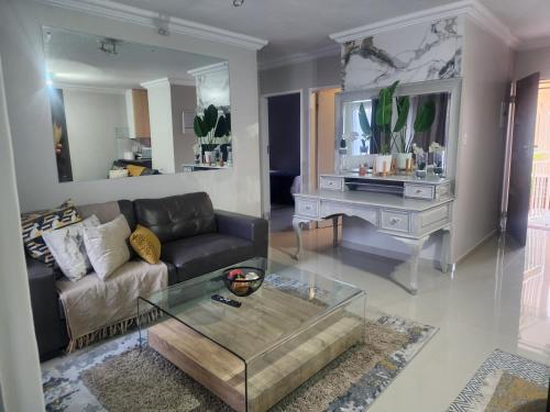 a living room with a couch and a table at Lemon tree in Pretoria