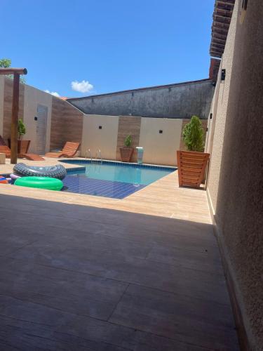 a swimming pool in the middle of a building at Pousada e Restaurante o Portuga in São Miguel dos Milagres