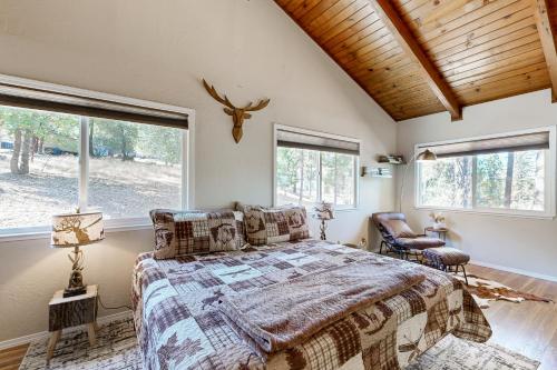 Un dormitorio con una cama grande y dos ventanas. en Green Abode, en Groveland