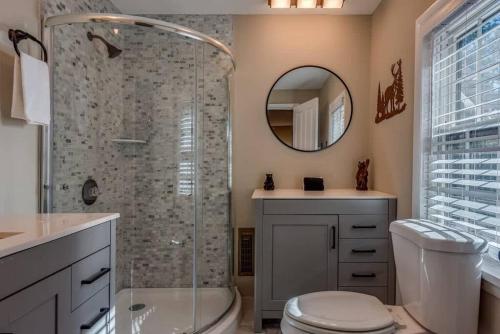 a bathroom with a shower and a toilet and a sink at The HYLANDS - Stunning Unique Mountain Home - Spa in Lake Harmony