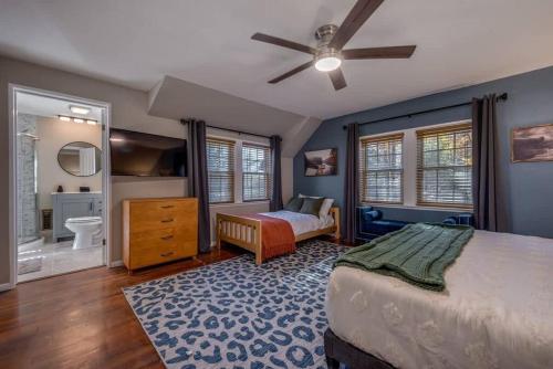 a bedroom with a large bed and a bathroom at The HYLANDS - Stunning Unique Mountain Home - Spa in Lake Harmony
