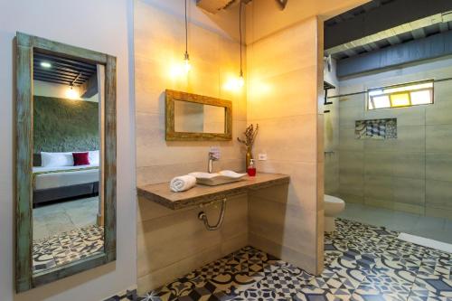 a bathroom with a sink and a shower at NQ Hotel Orinoquia in Villavicencio