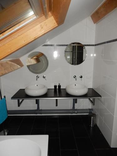 a bathroom with two sinks and a mirror at Vakantievilla Värmland, Zweden in Filipstad