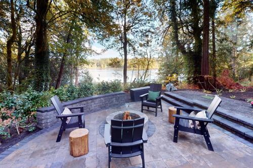 a patio with chairs and a table and a fire pit at Dome Away From Home in Gig Harbor