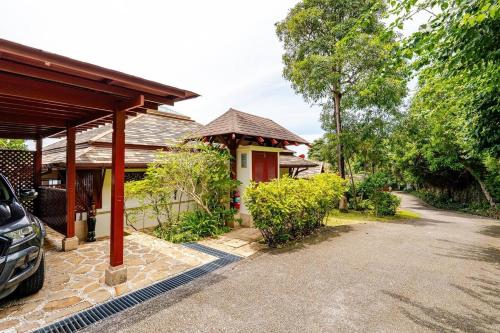a house with a car parked in front of it at Patong Seaview Luxury Villa Penda in Patong Beach