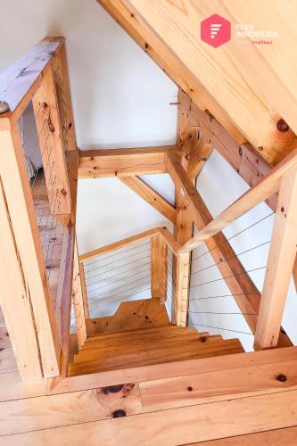 an overhead view of a wooden staircase in a wooden house at Le Pèlerin - Rustique Écoresponsable En nature in Notre-Dame-Des-Bois