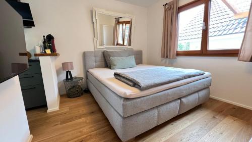 a bedroom with a couch with a pillow on it at Modernes Mini-Apartment in Kehl Kork in Kehl am Rhein
