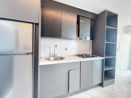 a kitchen with a sink and a refrigerator at Island Escape Properties 01 in Panama City