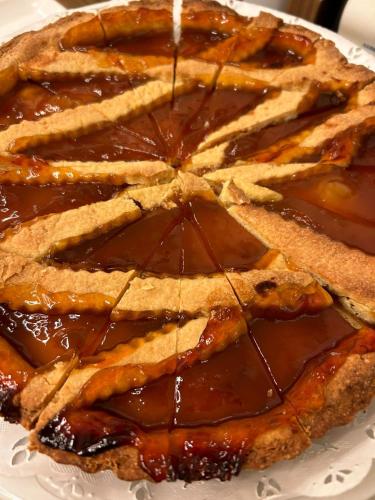 a pie with chocolate sauce on a white plate at Hotel Motel 2 in Tortona