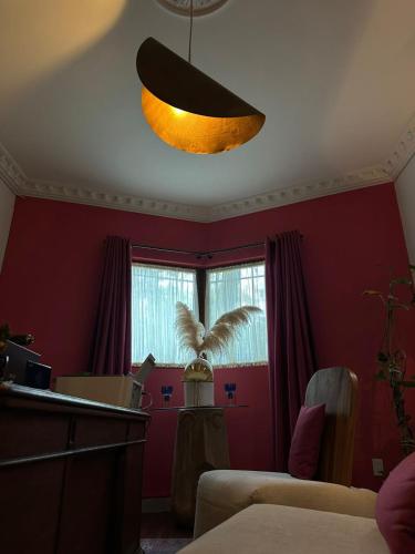 a room with red walls and a ceiling with a light at Nokal Exclusive Stay in Mexico City