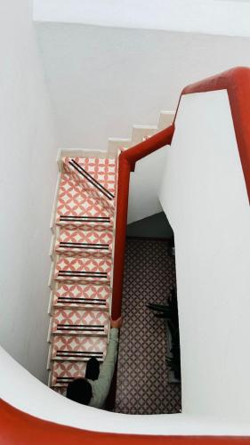 a staircase with an orange and white stair case at Nokal Exclusive Stay in Mexico City