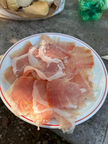 a plate of ham on a table with at Moulin a Vipava in Renče