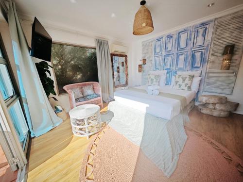 a bedroom with a large bed and a tv in it at Beachwood Camps Bay in Cape Town